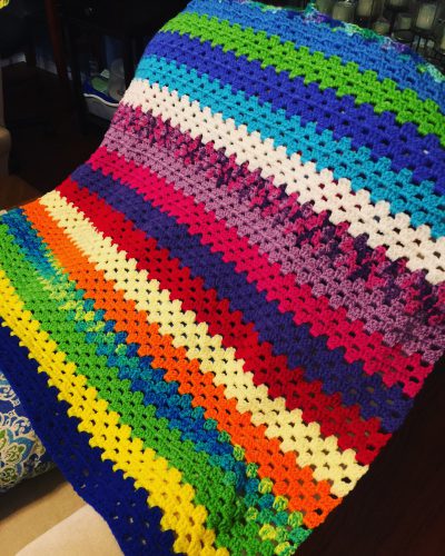 This afghan is full of bright, cheery colors to bring happiness and hugs to its recipient. It should be done soon.